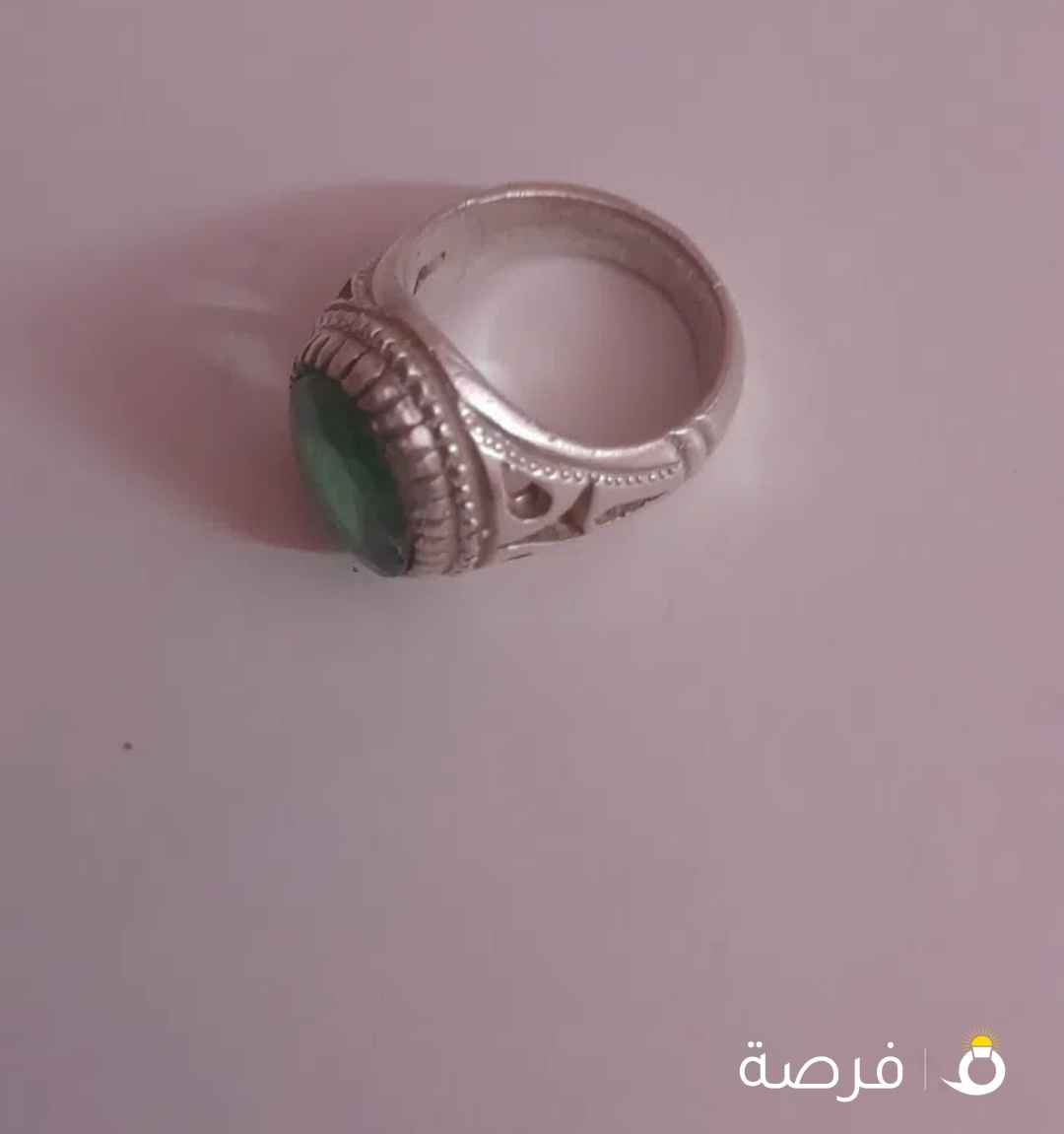 green stone with silver ring