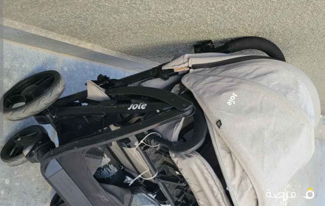 عربة للأطفال مقعدين مع ضلالة من الشمس